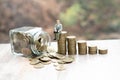 The coin ladder has a businessman. business and saving money concept. Tiny people sitting on a pile of coins Financial concepts. Royalty Free Stock Photo