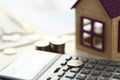 Coin Lay on Calculator, House Model on Office Desk Royalty Free Stock Photo