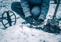 The coin is lucky find while searching for treasures with a metal detector in field. The man's hand takes the found ancient