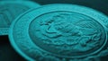 Coin 5 Mexican pesos close up. Peso of Mexico. Reverse of coin with coat of arms of country. Eagle and snake. Turquoise tinted Royalty Free Stock Photo