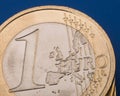 Coin one euro on a blue background. Euro money. Closeup. Royalty Free Stock Photo