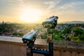 Coin Operated Binocular viewer next to the green hill garden in the middle of old town Veszprem, Hungary at sunset