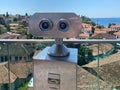 Coin Operated Binocular viewer next to the waterside promenade in Phuket looking out to the Bay. Landscape with beautiful cloudy Royalty Free Stock Photo