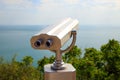 Coin Operated Binocular viewer or touristic telescope, trees and sea, panoramic view. Closeup Royalty Free Stock Photo