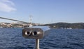 Coin-operated binoculars close-up. View of the Bosphorus Bridge in the background. Photographed outdoor in sunny