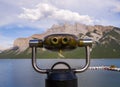 Coin operated binoculars on Lake Minnewanka. Summer vacation in the mountains - a trip to Banff, Alberta, Canada