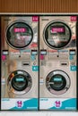 Coin-operated express laundry self-service washing and drying machine in Geylang, Singapore Royalty Free Stock Photo