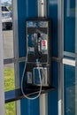 Coin operated telephone in phone booth