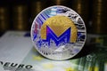 Coin physical Monero XMR with a blue tint