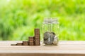 Coin Stack , coin in Glass bottle  in green bokeh background. Save Coin in Jar isolated on white or gray background. Business Royalty Free Stock Photo