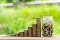 Coin Stack , coin in Glass bottle  in green bokeh background. Save Coin in Jar isolated on white or gray background. Business Royalty Free Stock Photo