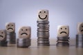 Coin stacking on smiley face and sad face for good financial planing can make happiness in life, Money saving and investment