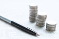 Coin stacks, pen and savings account passbook or financial statement on office desk table Royalty Free Stock Photo