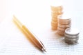 Coin stacks, pen and savings account passbook or financial statement on office desk table Royalty Free Stock Photo