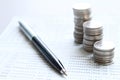 Coin stacks, pen and savings account passbook or financial statement on office desk table Royalty Free Stock Photo