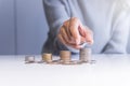 Hand with coin stacks on a table,Saving money concept Royalty Free Stock Photo