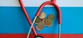 Coin stethoscope and Russian flag closeup. Problem of treatment in Russian Federation Royalty Free Stock Photo