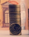 Coin of ten euro cents on the background of folded coins and a p Royalty Free Stock Photo