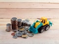 Coin tower with truck toys Royalty Free Stock Photo