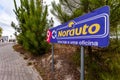 Coina, Portugal - October 23, 2019: Signpost pointing to Norauto car or auto parts shop and service station. Auto repair shop in