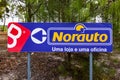 Coina, Portugal - October 23, 2019: Signpost pointing to Norauto car or auto parts shop and service station. Auto repair shop in