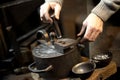 Coinage craftsman stamping coins with hammer and anvil.