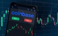 Coinbase cryptocurrency platform company shares rise or fall on stock exchange market - logo in trading app on mobile phone screen Royalty Free Stock Photo