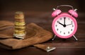 Coins with alarm clock, retirement savings and pension planning Royalty Free Stock Photo