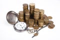 Coins and Antique pocket watch on white background Royalty Free Stock Photo