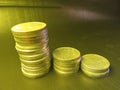 Coins arranged in tiers on black background