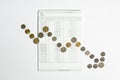 Coins array to show graph going down on bank saving account book Royalty Free Stock Photo