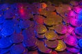 Coins background concept in neon pink and purple color. Coin Gambling, arcade tokens Royalty Free Stock Photo