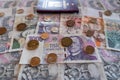 coins and banknote, euro and czech koruna side by side with passport in background, CZK EURO EUR