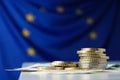 Coins and banknotes on table against European Union flag, space for text Royalty Free Stock Photo