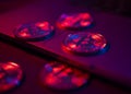 The coins of Bitcoin are on the laptop Surface. Purple and pink neon light