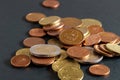 Coins on a black table. Close-up of euro coins, euro cent with the coat of arms of Latvia. Soft focus