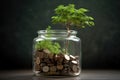 Coins in a bottle and the green tree, Represents the financial growth. The more money you save. Royalty Free Stock Photo