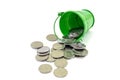 Coins of 5 cents and a green bucket on a white background. Coins get enough sleep from a bucket. Ukrainian money.