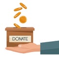 Coins depositing in a carton box with banner of text donate on a hand