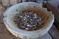 Coins of different countries in an ancient bowl