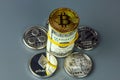 Coins of different crypto-currencies with dollars.