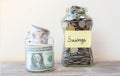 Coins and dollars savings in glass jar filled Royalty Free Stock Photo