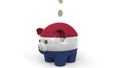 Coins fall into piggy bank painted with flag of the Netherlands. National banking system or savings related conceptual