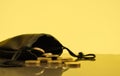 Coins falling out of a money pouch, golden background Royalty Free Stock Photo