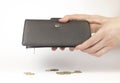 Coins falling out of a wallet. A leather wallet in the hands of a woman. Coins are falling out of the wallet. Royalty Free Stock Photo