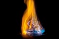 Coins on fire. The concept of high prices for natural gas. Royalty Free Stock Photo