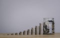 Coins in a glass bottle and stack of money coin step growing growth saving money, business financial and investment concept Royalty Free Stock Photo