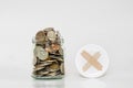 Coins in glass jar, and covered with cross symbol Royalty Free Stock Photo