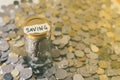 Coins in a glass jar with note written ` SAVING `. Royalty Free Stock Photo