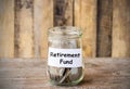 Coins in glass money jar with Retirement fund label Royalty Free Stock Photo